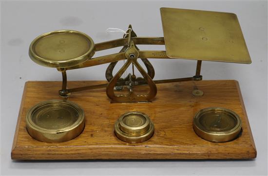 A set of mahogany and brass postal scales and weights